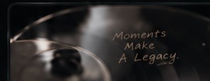 A close-up of a record with the words Moments Make A Legacy